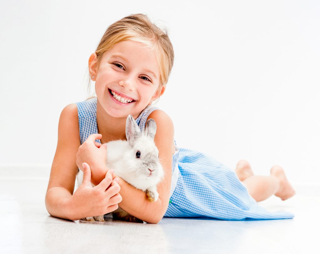 little girl holding a rabbit